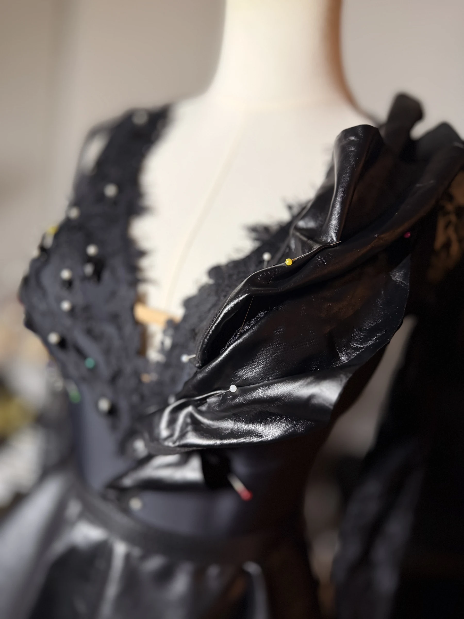Sculptural black detail pinned on the Eclipse gown