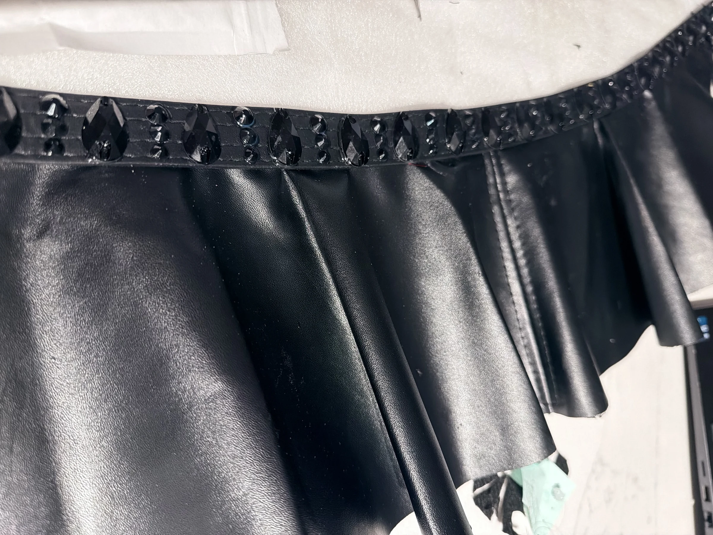 Sculptural peplum and crystal construction detail