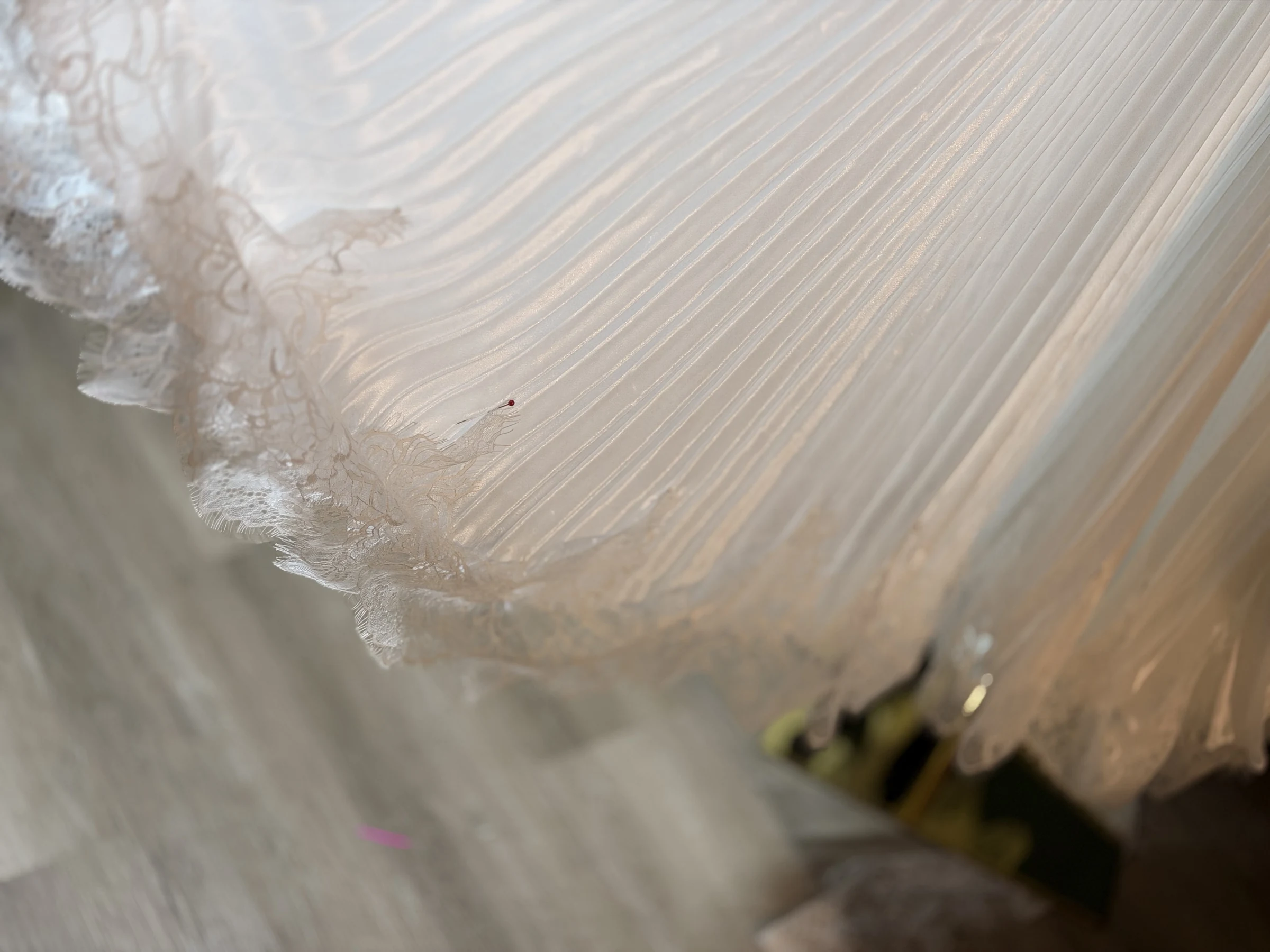 White pleated satin chiffon finished with lace