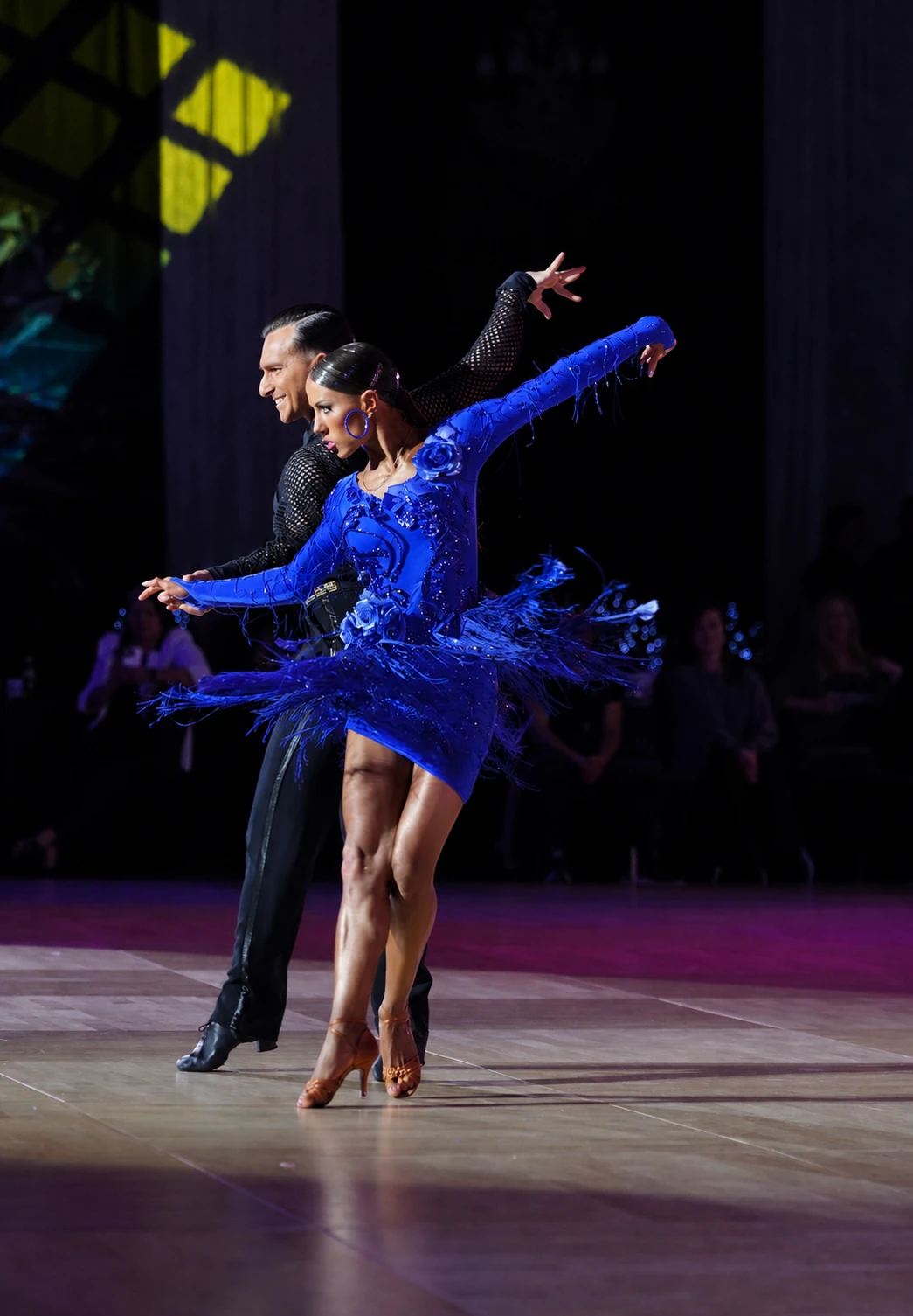 Dancer performing in a luminous blue gown
