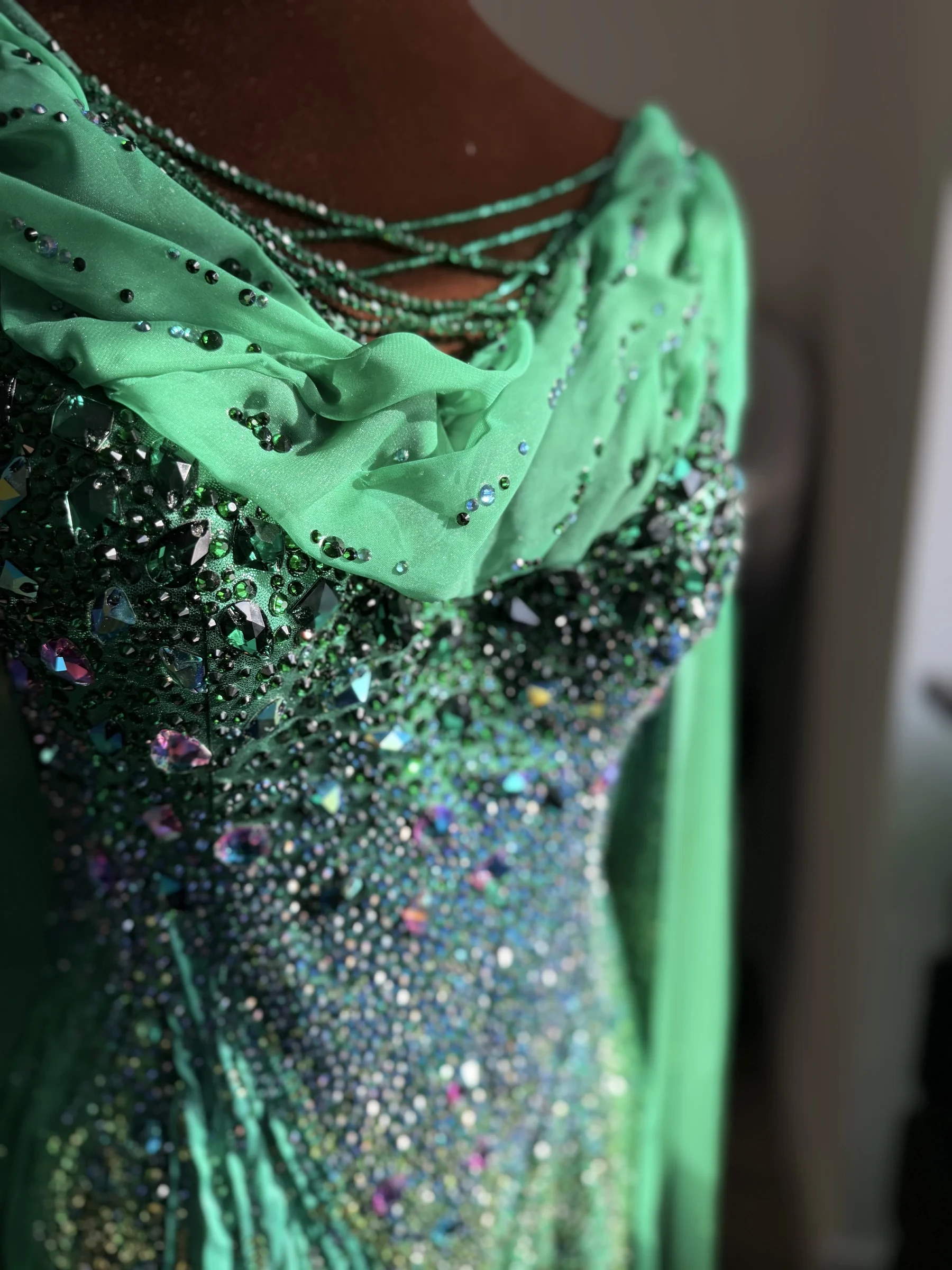 Aurora neckline, draping, and rhinestone detail