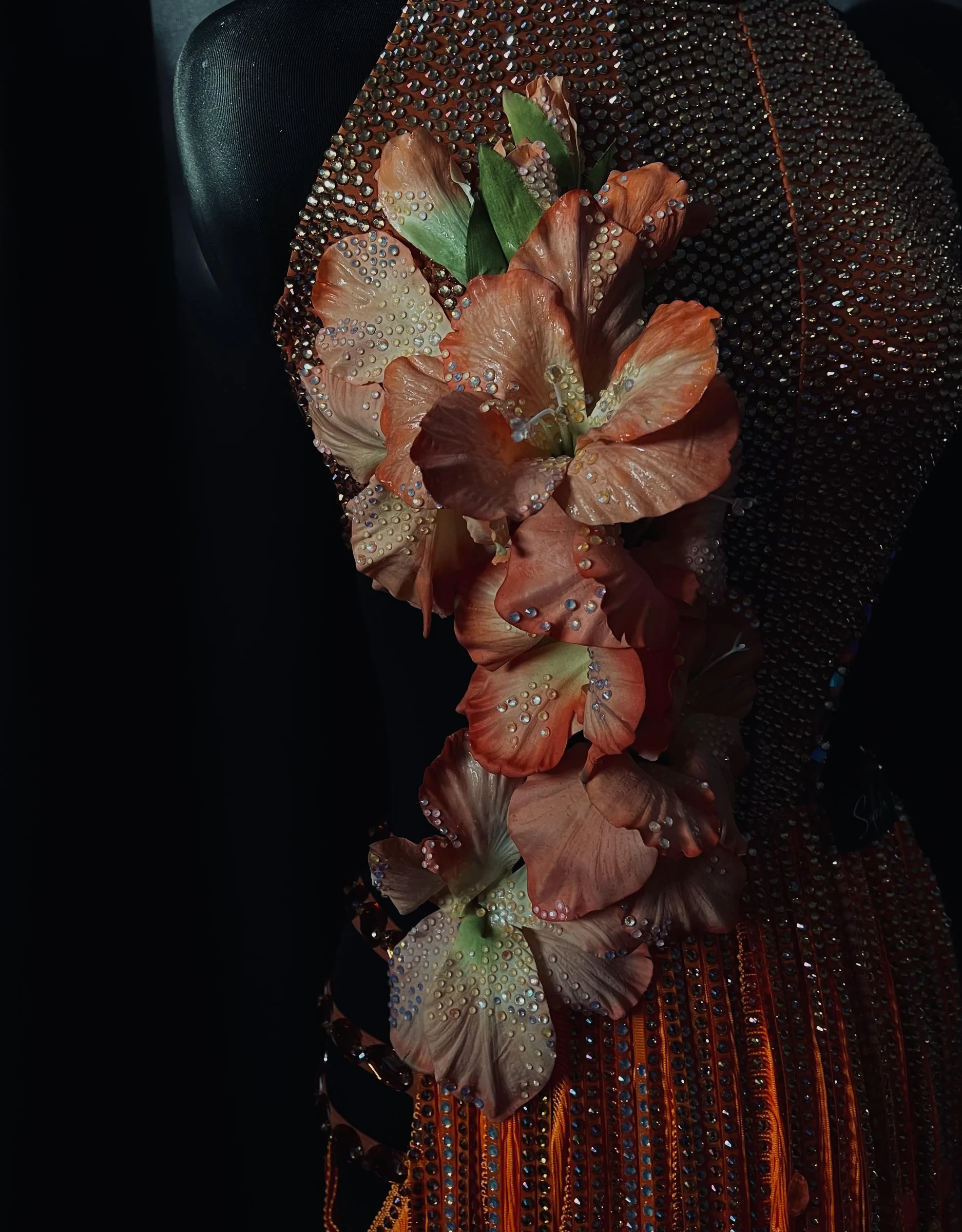 Orange couture gown with flowers and rhinestones